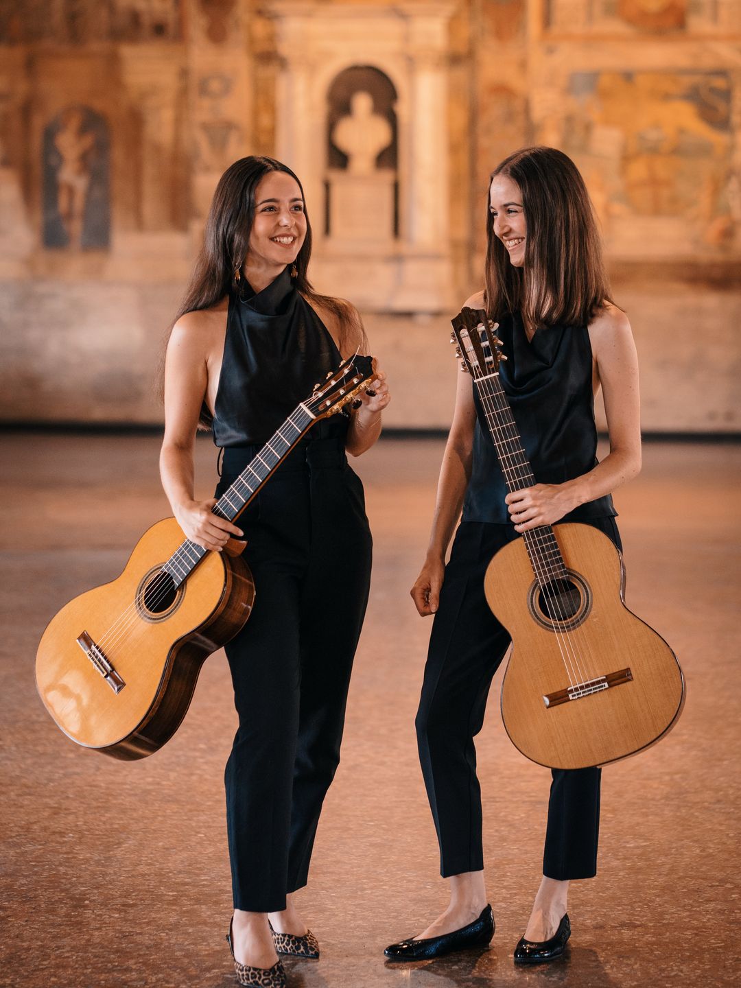 Alice Brandão and Maja Kralj smiling, each holding a classical guitar